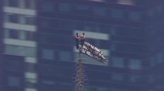 Individuals Ascend to Empire State Building's Pinnacle, Displaying Message